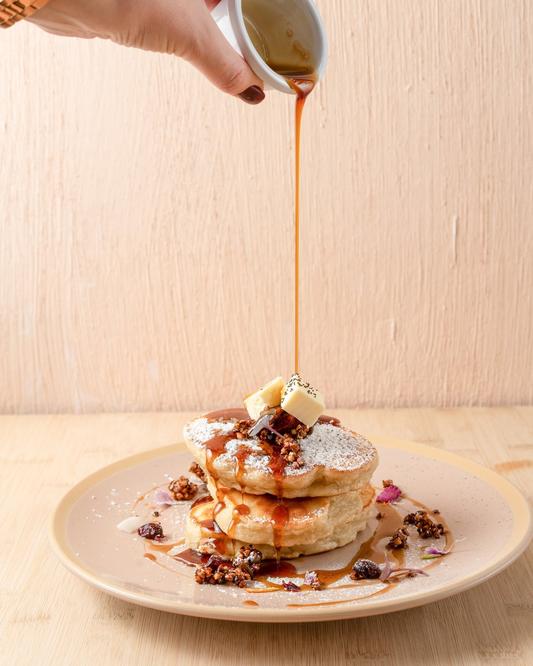 A stack of fluffy Canadian pancakes drizzled with maple syrup